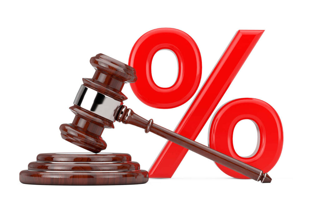A wooden gavel and sound block alongside a red percent symbol, representing legal settlements and attorney fees.